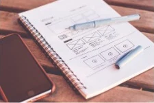 Website wireframes sketched in a notebook